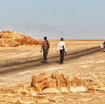 soldiers with rifles patrolling the desert in Africa 