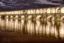 illuminate old bridge over a river 
