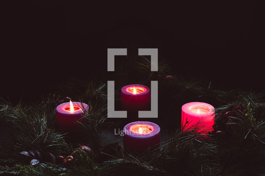 Rustic advent wreath with four candles lit