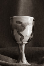 clay chalice on tan linen 