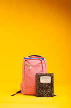 composition notebook and book bag