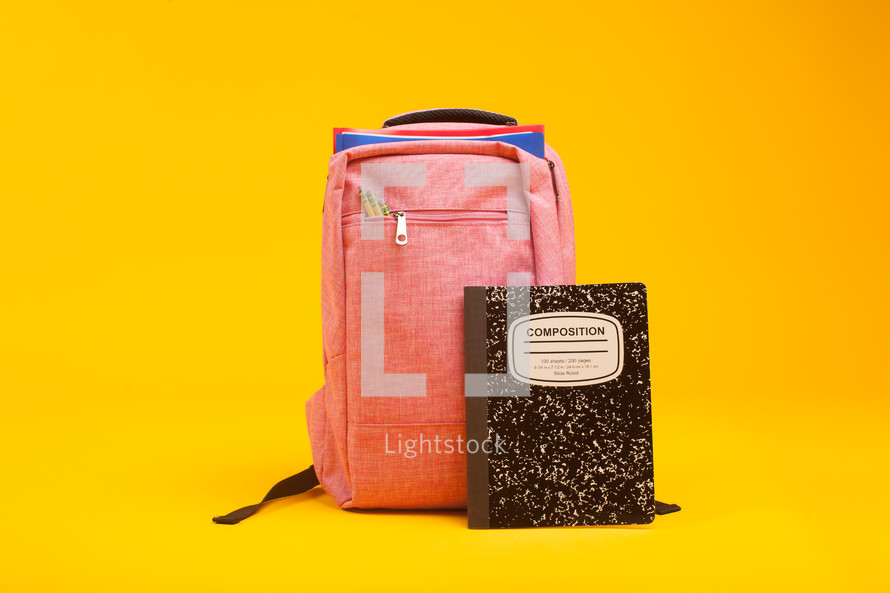 pink book bag and composition notebook 