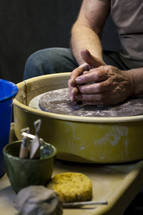 shaping clay on a potters wheel 