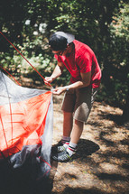 man setting up a tent 