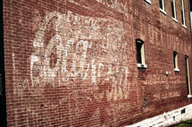 vintage coca-cola sign on a brick wall 