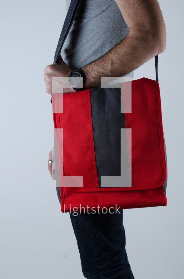 a man holding a satchel