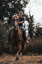 Horse riding woman on a brown stallion, western style saddle horseback rider