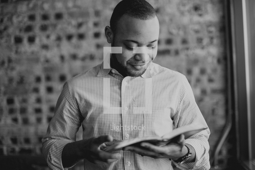 African-American man reading a Bible 