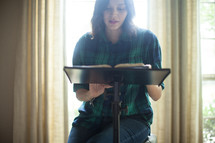 A young woman leading a Bible study.
