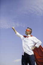 A Dad in a superhero cape with raised fist 