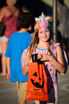 little girl in a Halloween costume trick-or-treating 
