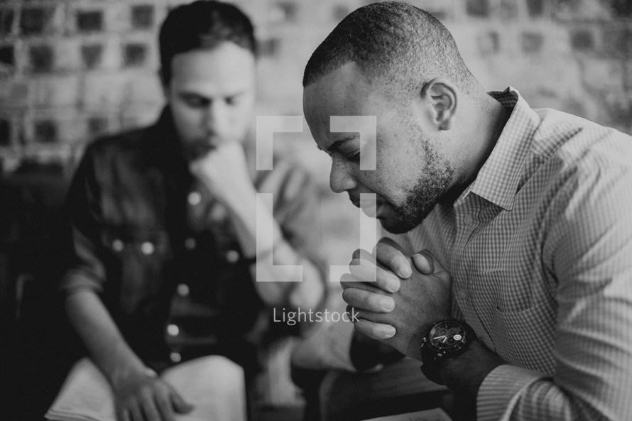 men praying at a prayer group