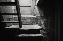 a stairway into dark basement
