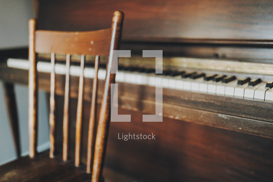 old wooden chair and piano