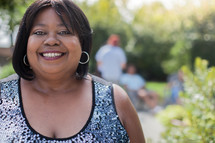 headshot of an African American woman at an outdoor summer party 