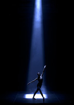 dancer under a spot light on stage