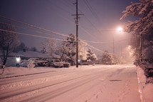 snow on a street at night 