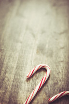 candy canes on wood background 