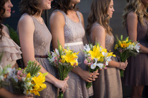 bridesmaids holding bouquets of flowers 