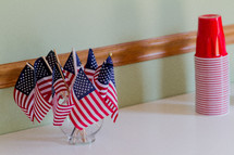 American flags in a vase and red solo cups 