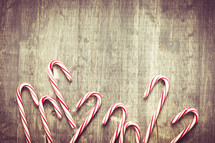 candy canes on a wood background 