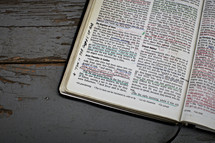 An opened Bible with the Gospel of God underlined