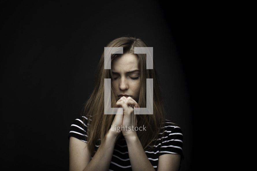 a teen girl in prayer 