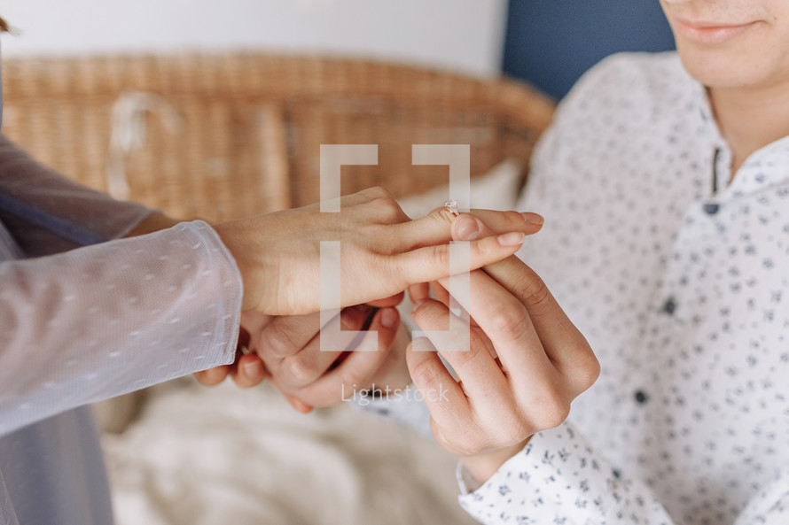 Close up young man putting wedding ring on woman bride finger, loving boyfriend proposing marriage to girlfriend, engagement, proposal acceptance concept, young couple decided getting married.