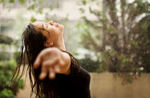 a woman enjoying the rain 