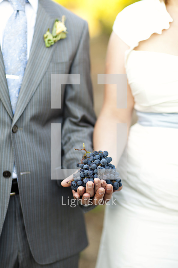 Couple holding bunch of grapes wedding marriage two become one
