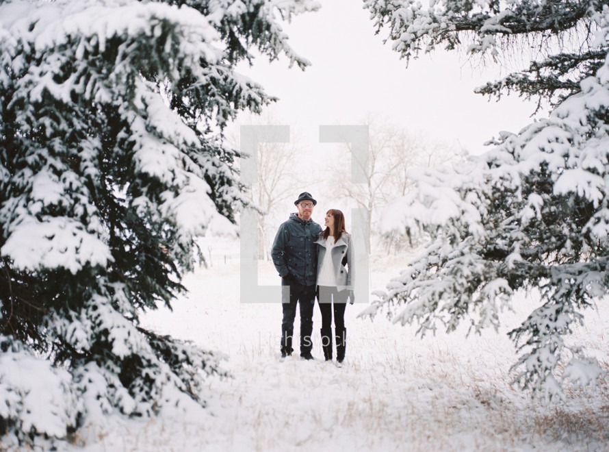 a couple in love standing outside in the snow 