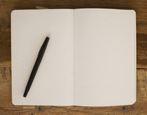pen on an open journal 