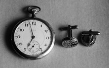 A pocket watch and cuff links.