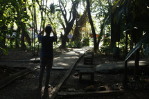 a man walking on a path through a jungle 