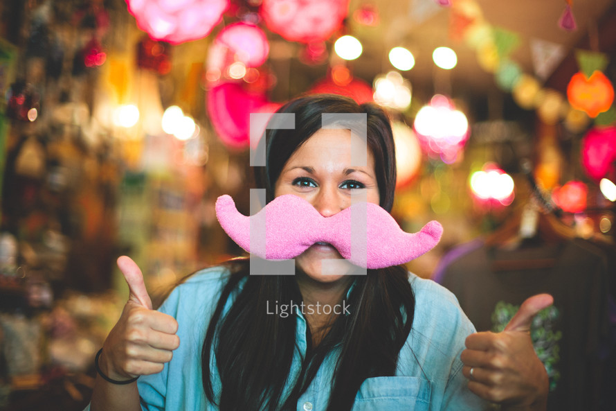 woman with a toy mustache 