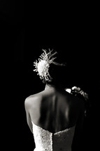 Back of bride in dress dramatic light hair piece