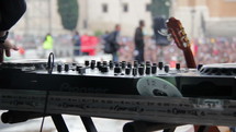man controlling a soundboard at a concert 