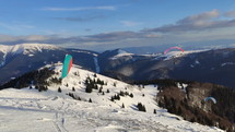 Proximity paragliding flying over snowy mountains, Freedom adrenaline sport flight
