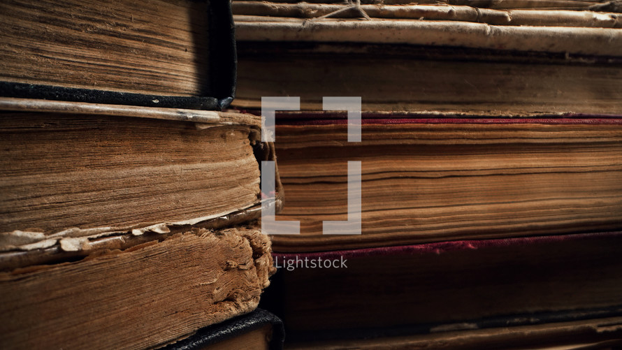 Old books in antique shop or abandoned library. Macro footage. Bookstore in vintage style. Literature, knowledge, information concept. High quality