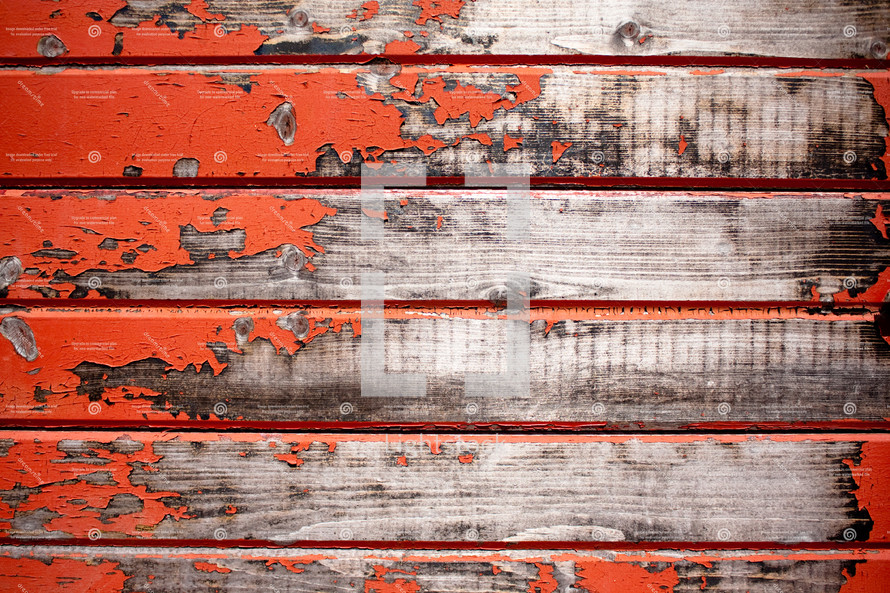 red peeling paint on old barn wood 
