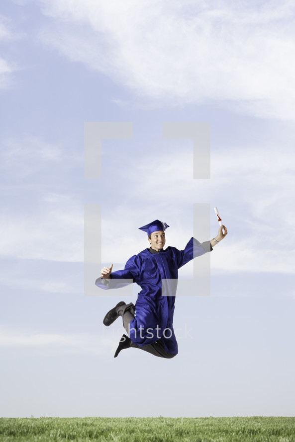 Graduate with diploma jumping for joy!
