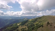 Paragliders flying in sunny mountain in summer nature landscape, Paragliding Adrenaline Adventure Aerial view
