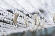 Many small icicles hanging from clothes line during an ice storm.