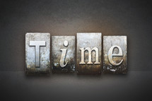 Tiles spelling the word "time."