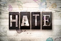 word hate on wood background 