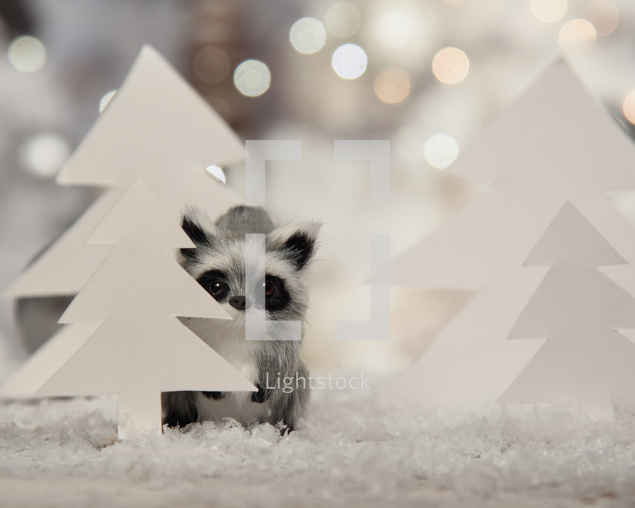raccoon figurine in snow 