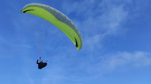 Paraglider flying over blue sky. Freedom paragliding adventure extreme sport
