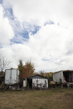 old shed and truck trailers used as storage on a farm