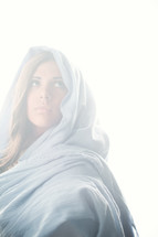 Mary in a blue shroud in bright light 