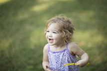 a toddler blowing bubbles 